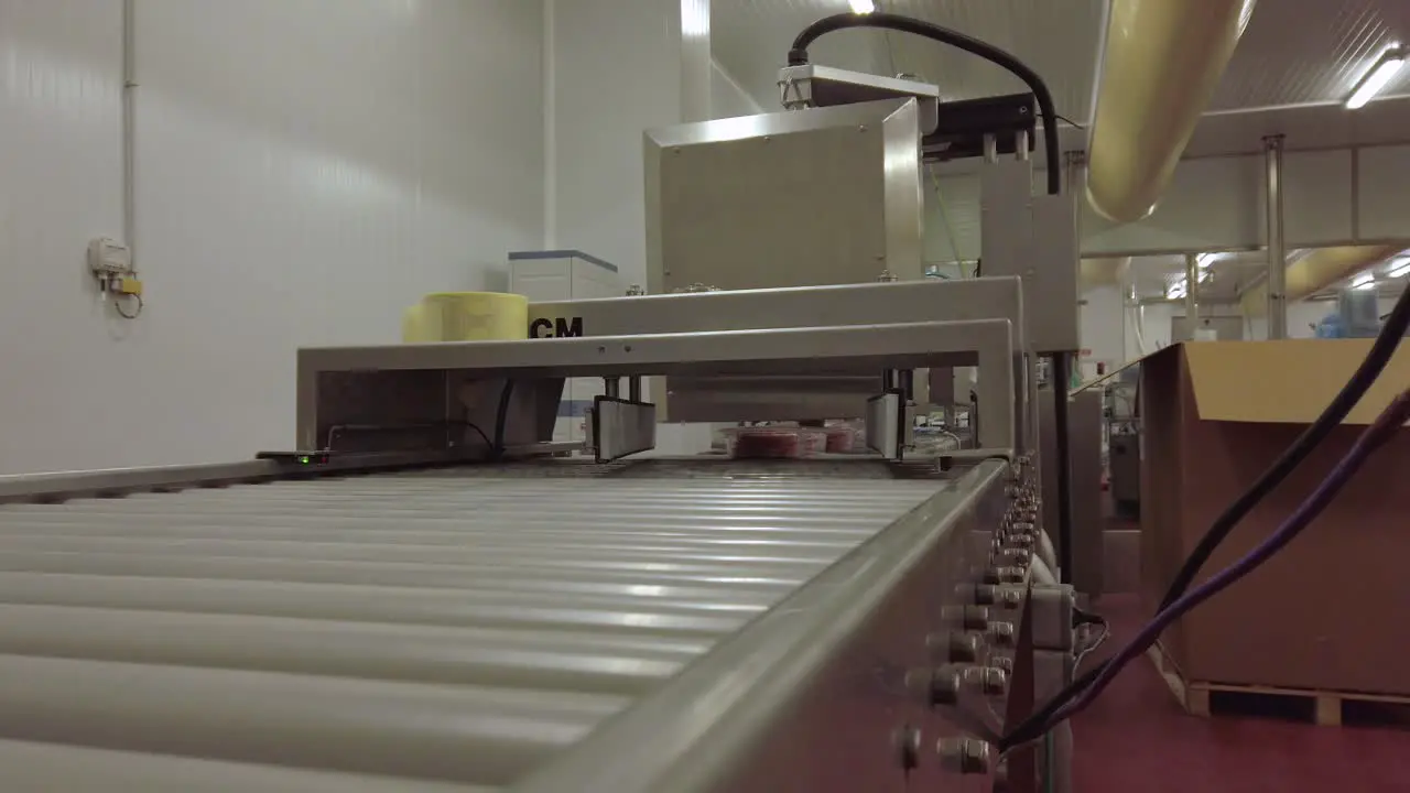 A shot of burger trays coming to the camera from a conveyor table