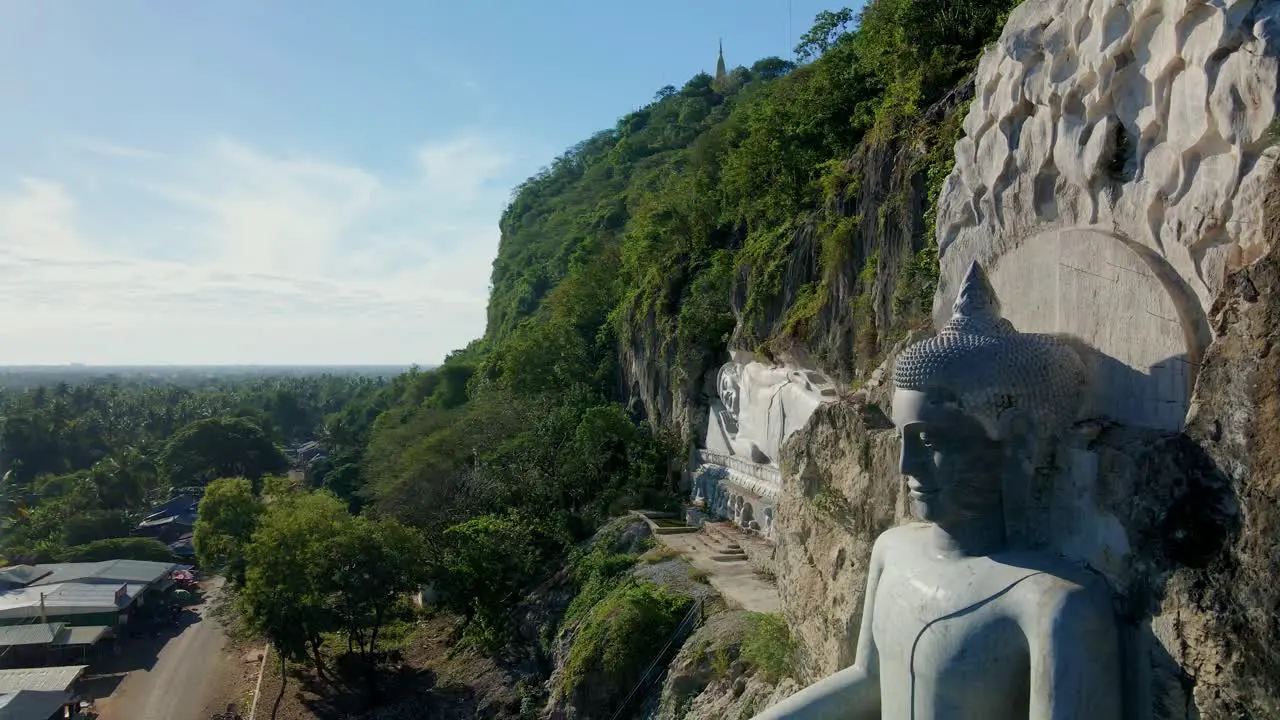 Giant Buddha rock carving in the side of mountain Phnom Sampov Battambang Cambodia