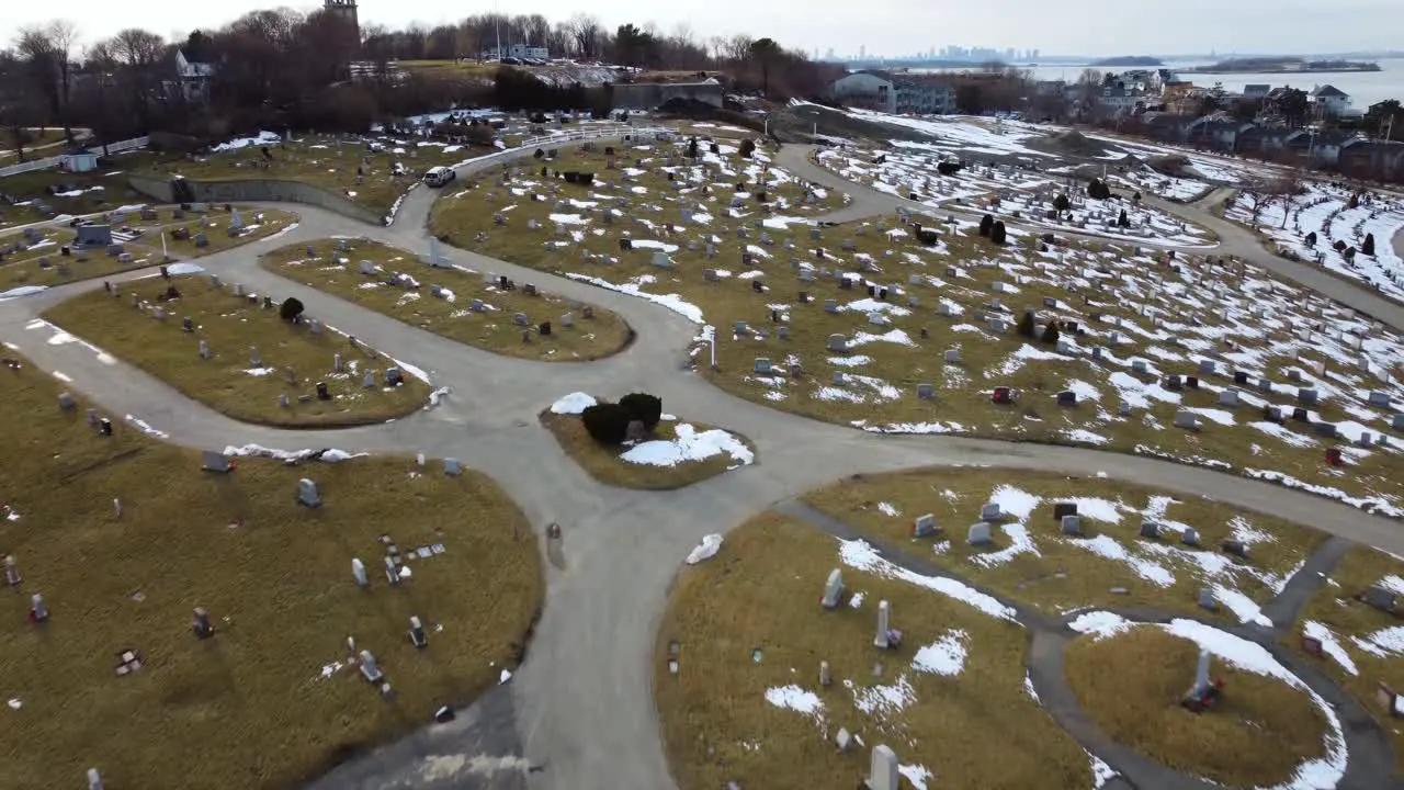 Aerial view of a cemetery during late winter with few snow left