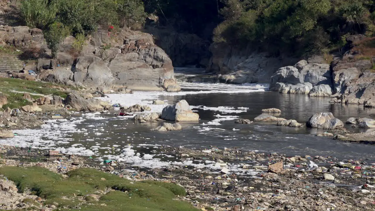 The pollution of the Bagmati River as it exits the Kathmandu Valley in Nepal and the foam that is floating on top