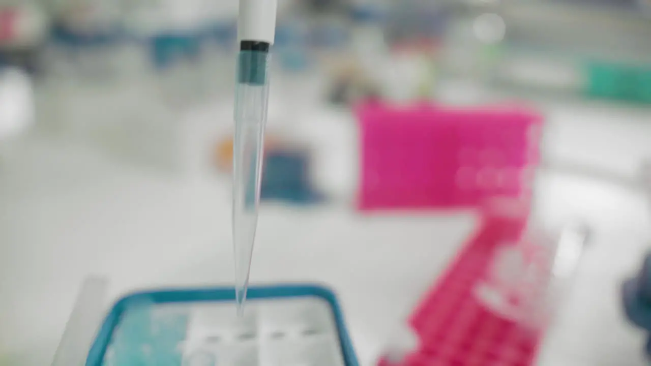 Scientist's hand holding pipette using DNA analysis for patient