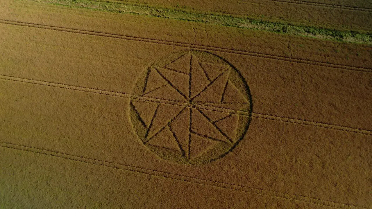 Strange wheat field crop circle farmland vandalism aerial birdseye rotate right view Stanton St Bernard Wiltshite