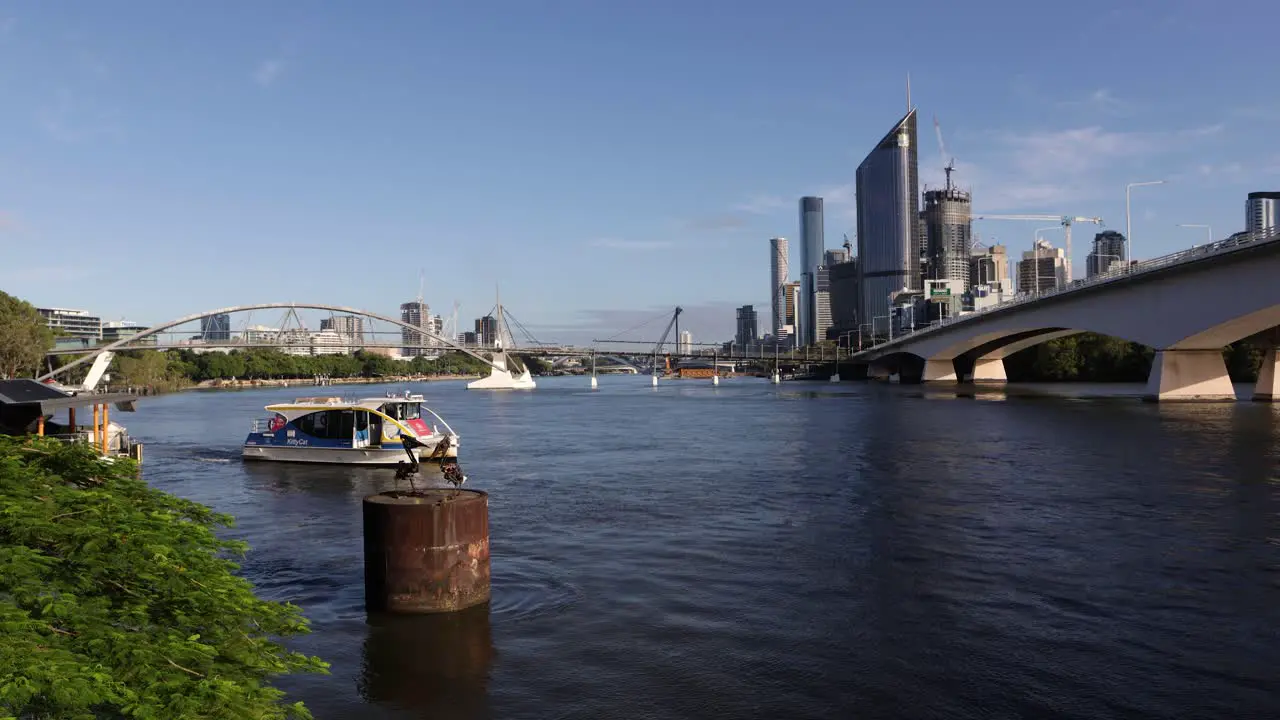 View of a ferry and Brisbane City on a sunny day in the morning