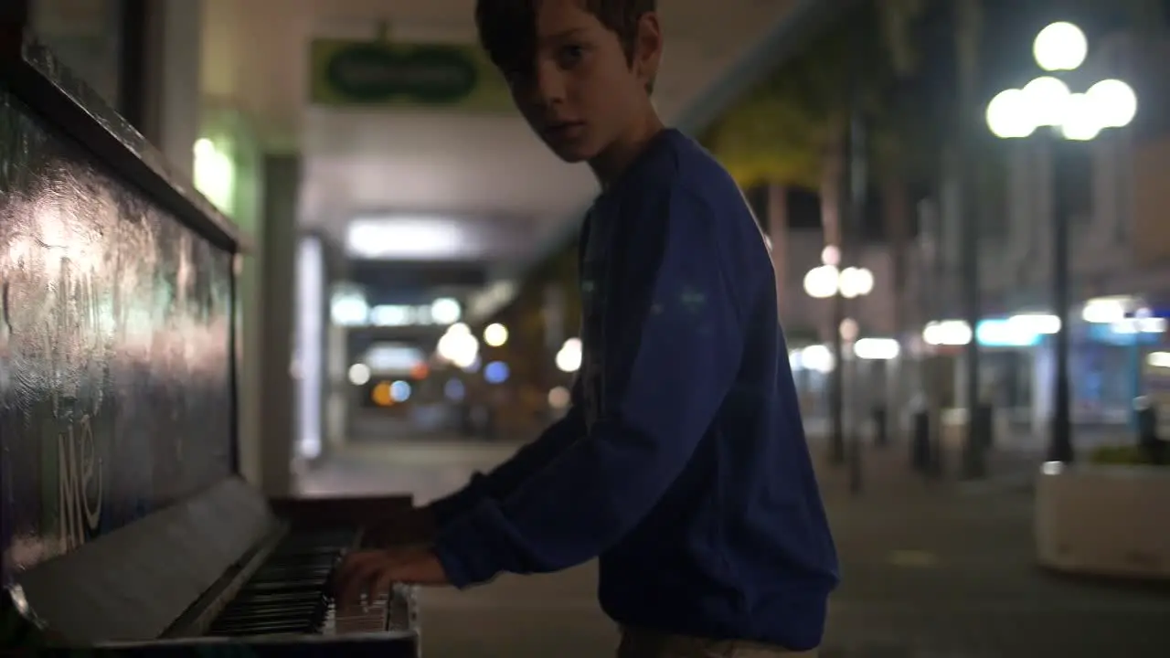 Young Boy Plays Piano in Street