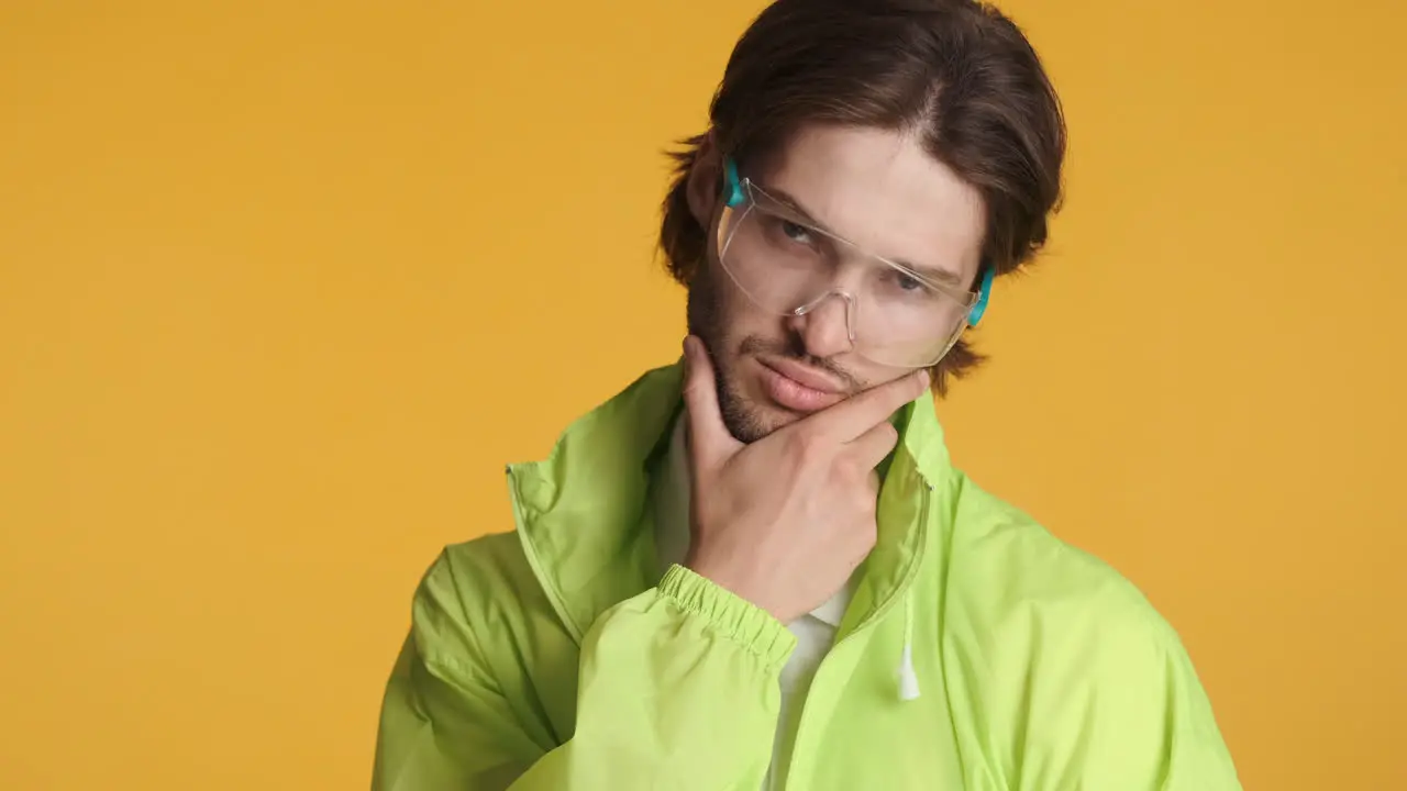 Caucasian man in front of camera on yellow background