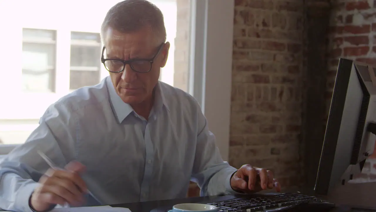 Mature Businessman Working On Computer In Office Shot On R3D