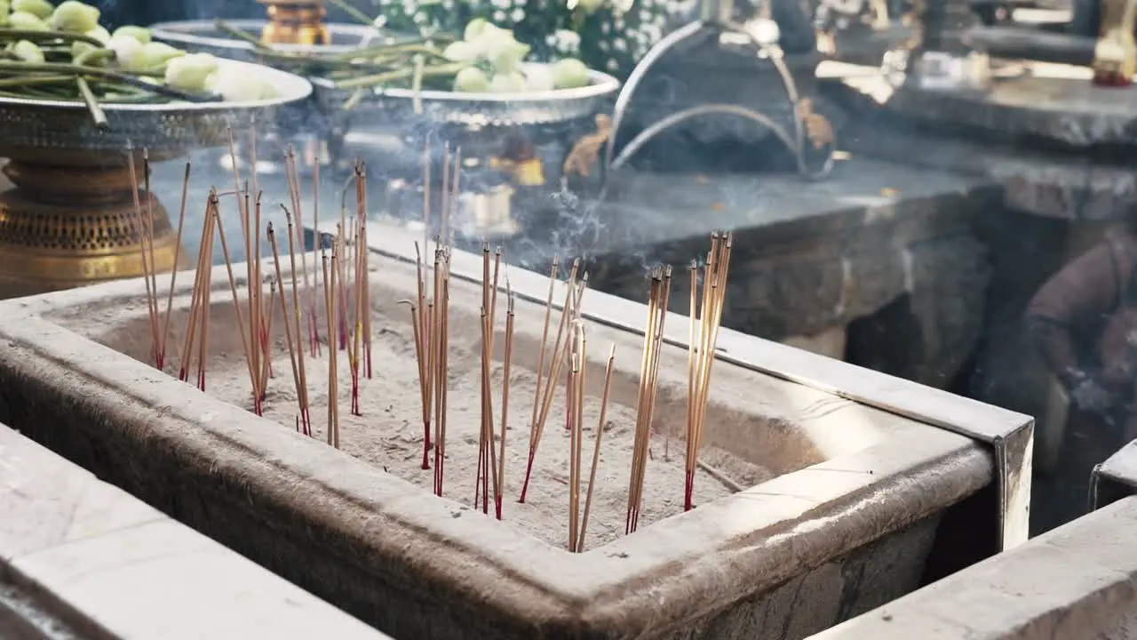 Wide shot of incense burning outside Asian temple