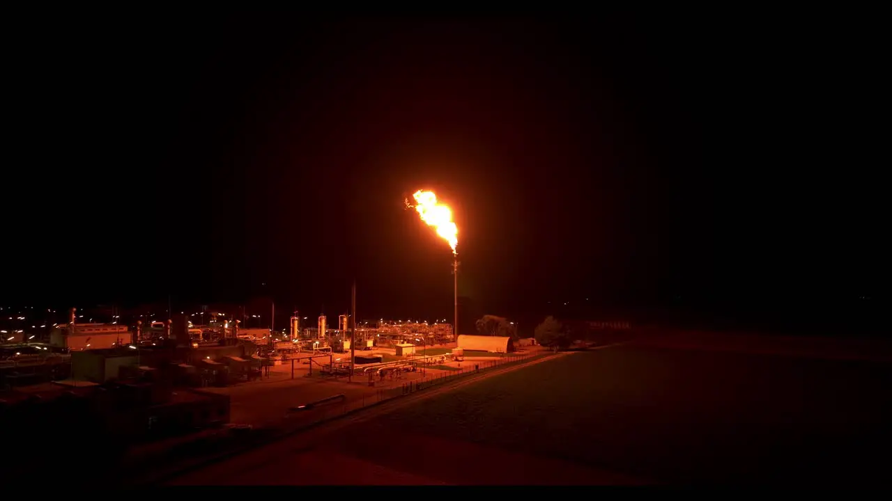 Gas flaring Illuminates the Surrounding Area with its Radiant Light Drone Flying Forward