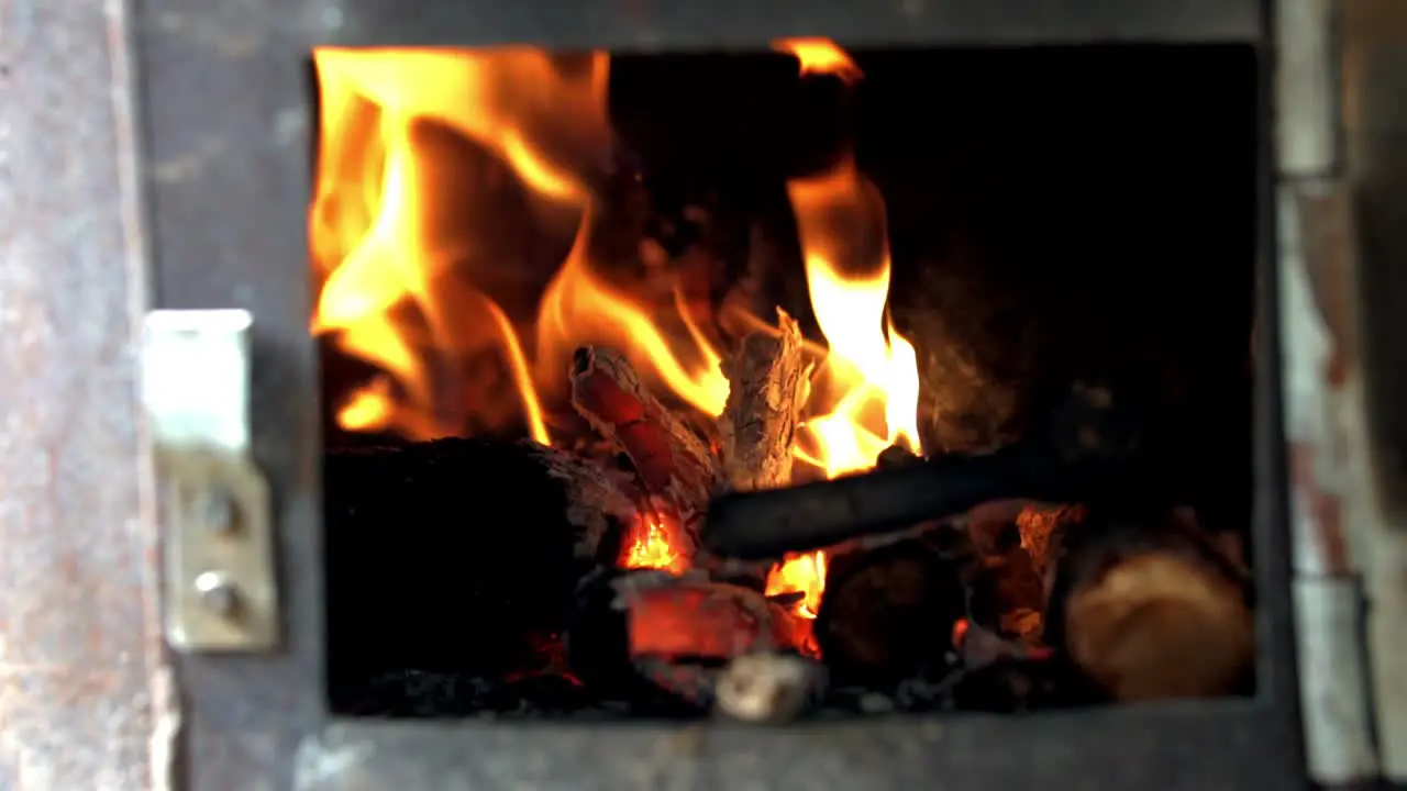 Flames of fire dancing wildly in an old rusty fireplace SLOW MOTION