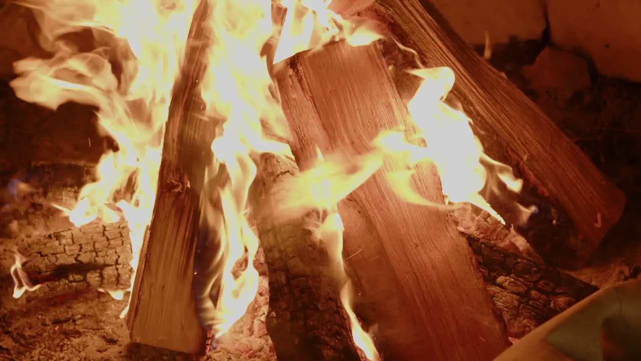 Slow motion close up of crackling campfire at night