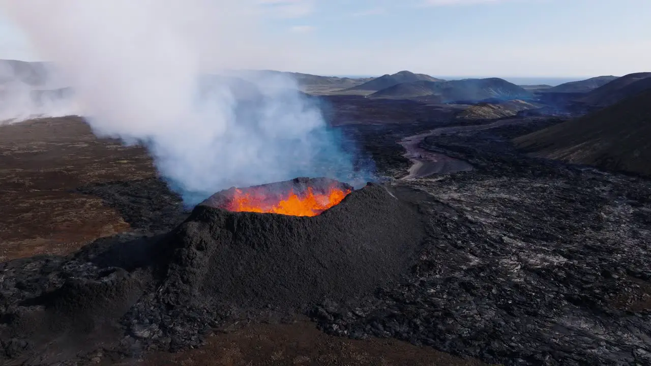 Volcano crater with hot molten magma forming new land in Iceland aerial