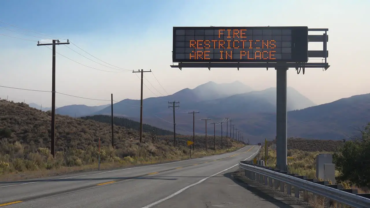 An Electronic Sign Along A Highway Warns That Fire Restrictions Are In Place As The Caldor Fire Rages In The Background Near Lake Tahoe California