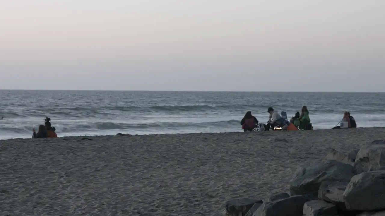 People on a beach in Carlsbad California during sunset