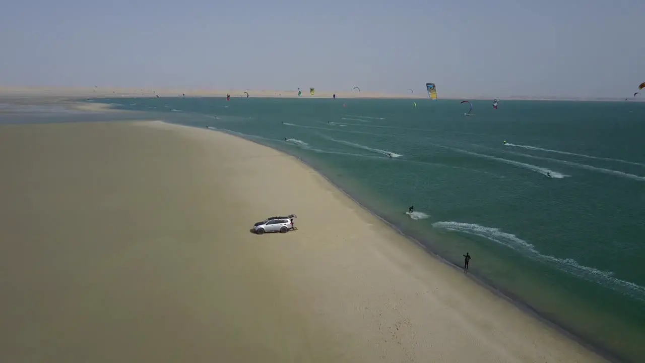 Drone footage of kitesurfers doing jumps and surfing on the beach of Dakhla Morocco