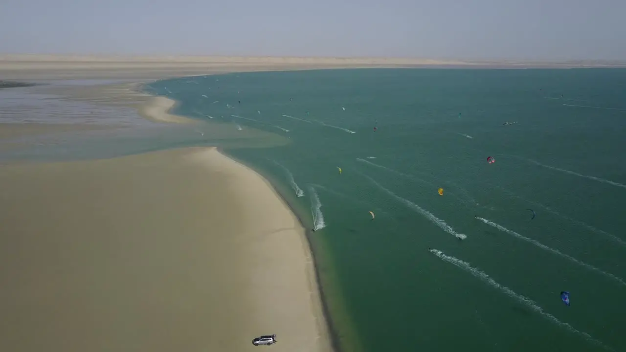 Drone shot of kiteboarders surfing on the coast of Dakhla Morocco