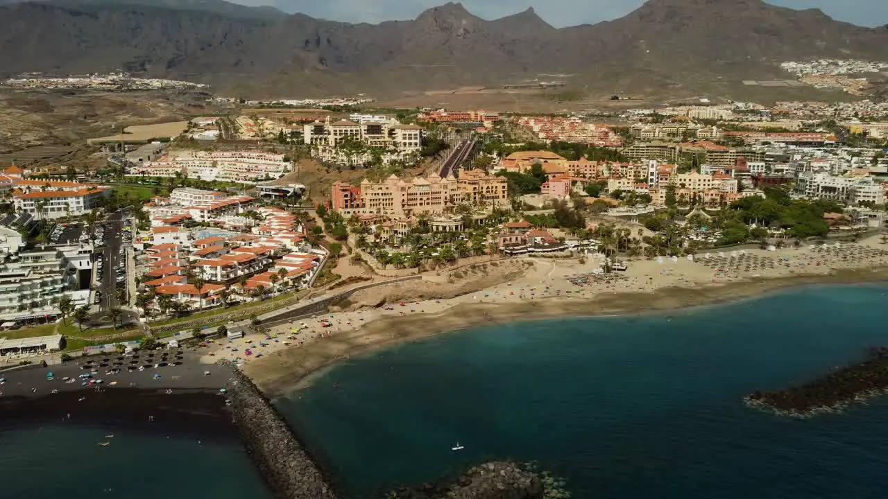 Awesome Panoramic view Of City Spain Tenerife At Seaside Seashore Blue Water Sea With Beach Rocks And Mountains In the Background