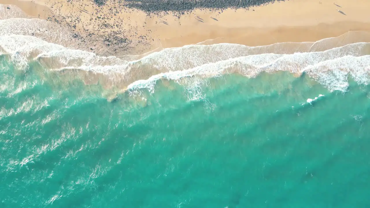 Spectacular aerial top view background photo of ocean sea water white wave splashing in the deep sea