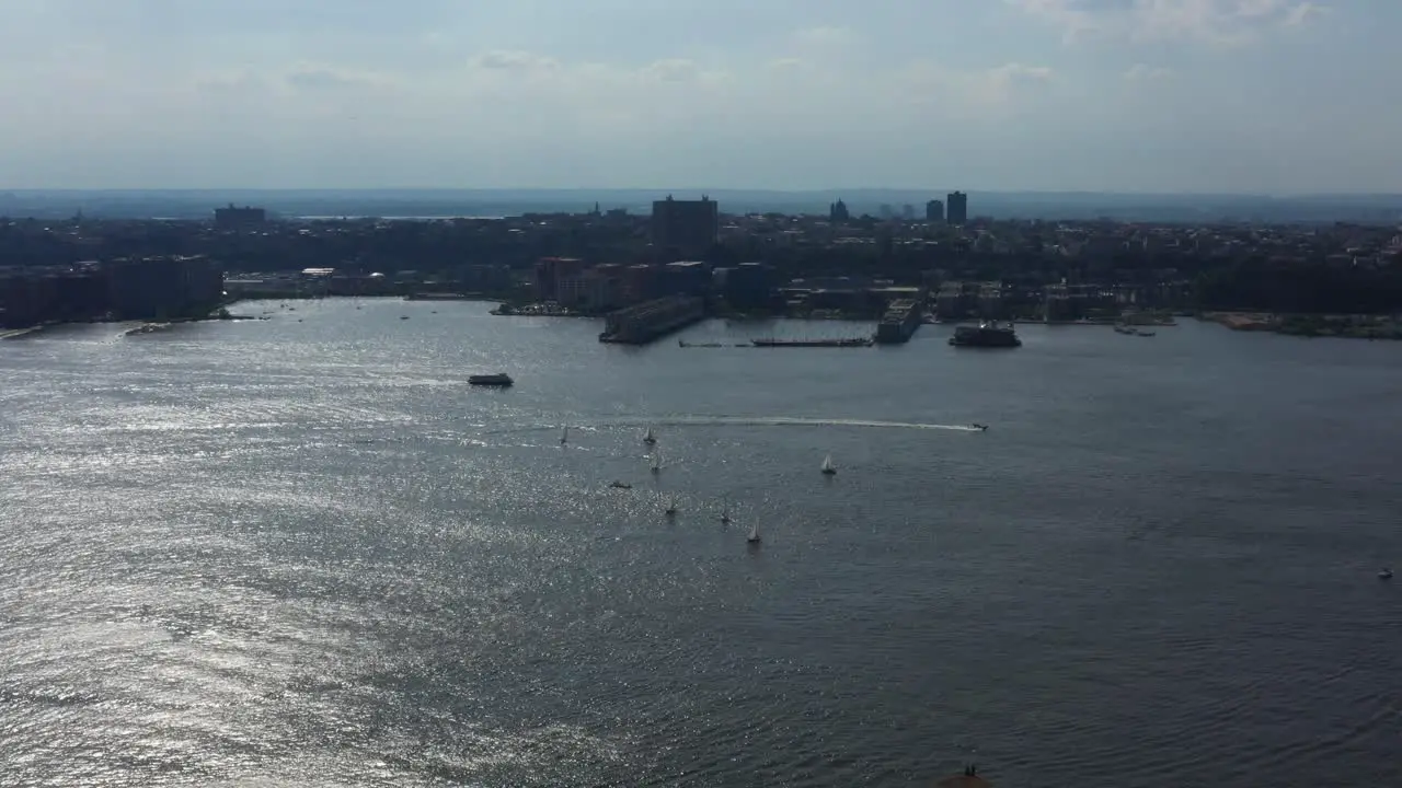 aerial high flown drone pan right while viewing boats in the Hudson River looking towards New Jersey