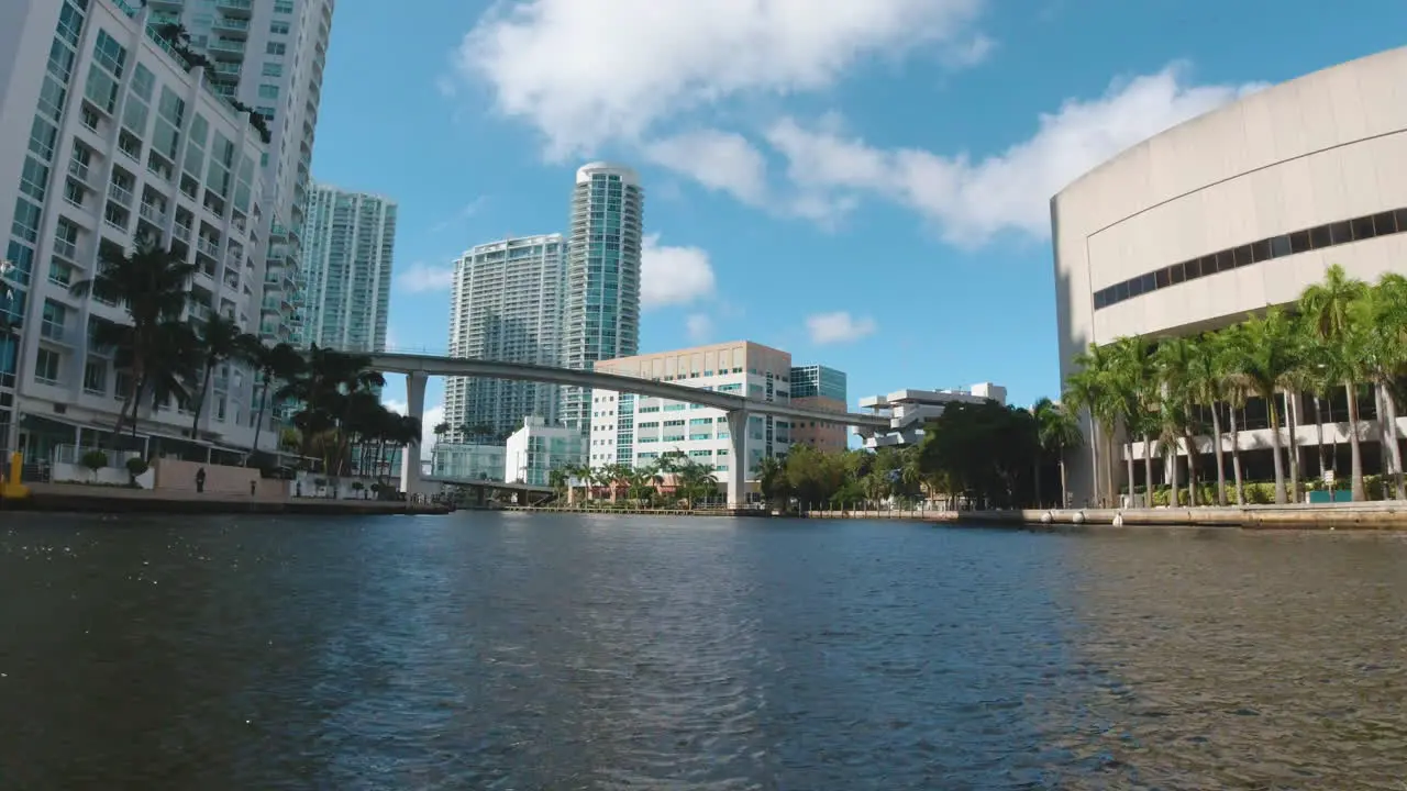 cityscape of Miami Florida by boat with tall buildings and palm trees along the coastline