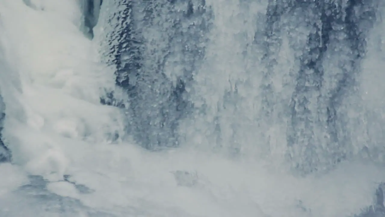 Winter background Water flowing under transparent ice Ice surface