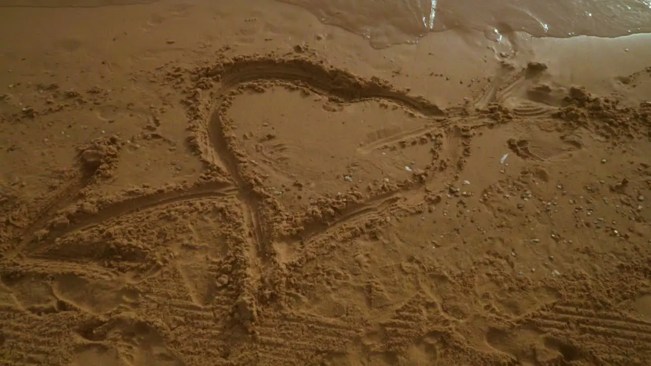 Heart sand Heart drawing on sand beach Panning from heart sign on sand to sky