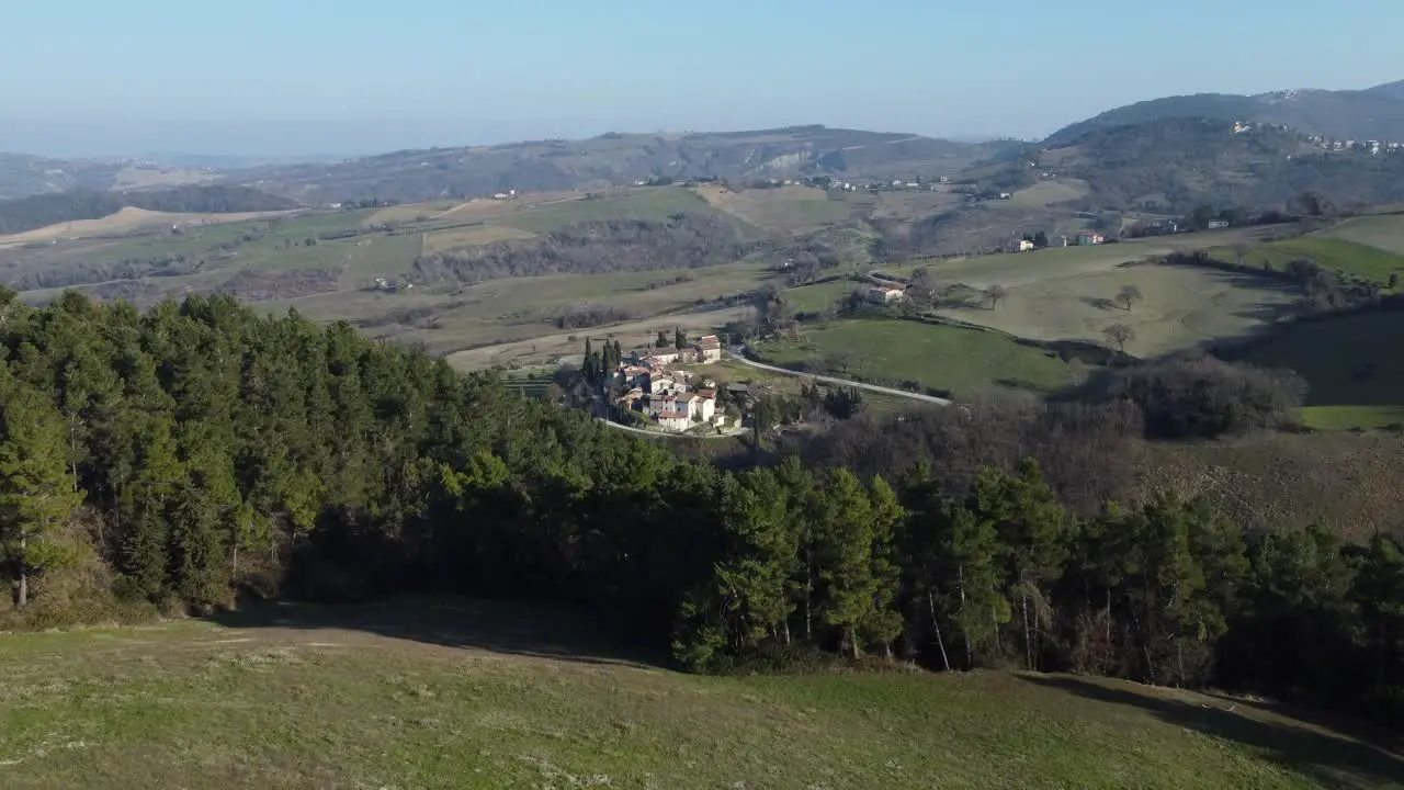 Italian village behind forrest revealing