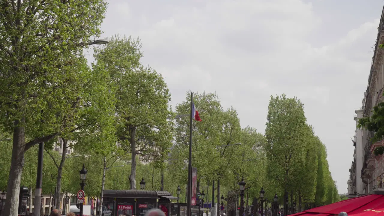 French Flag on Champs-Élysées on a busy day in Spring 4K