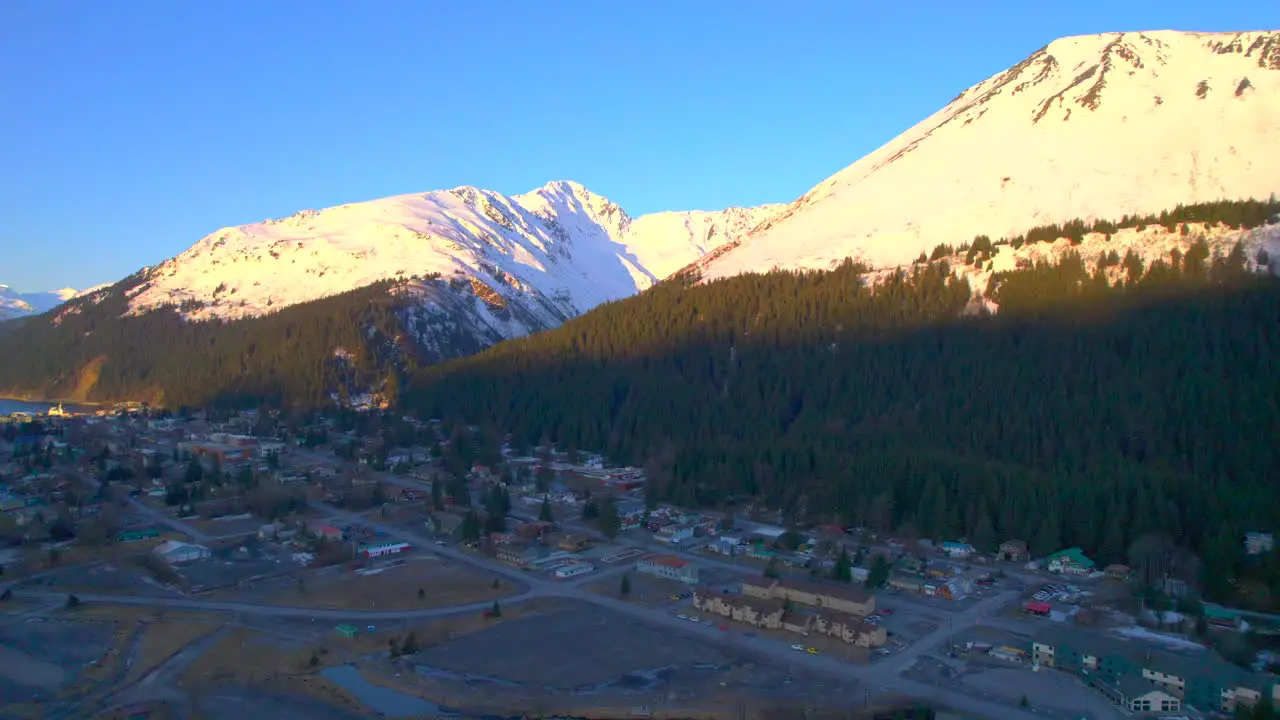 Sunrise left to right panoramic view of the mountains and downtown of Seward Alaska