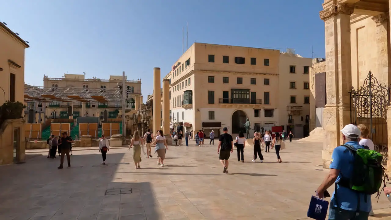 Slow motion shot of people walking through the streets of Valletta Malta