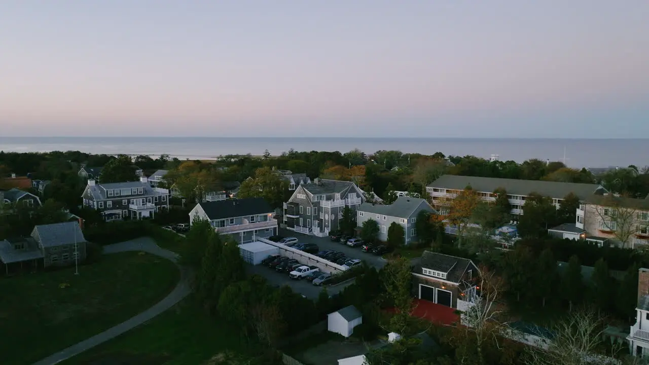 Aerial drone of Edgartown houses Martha's Vineyard over houses at dusk