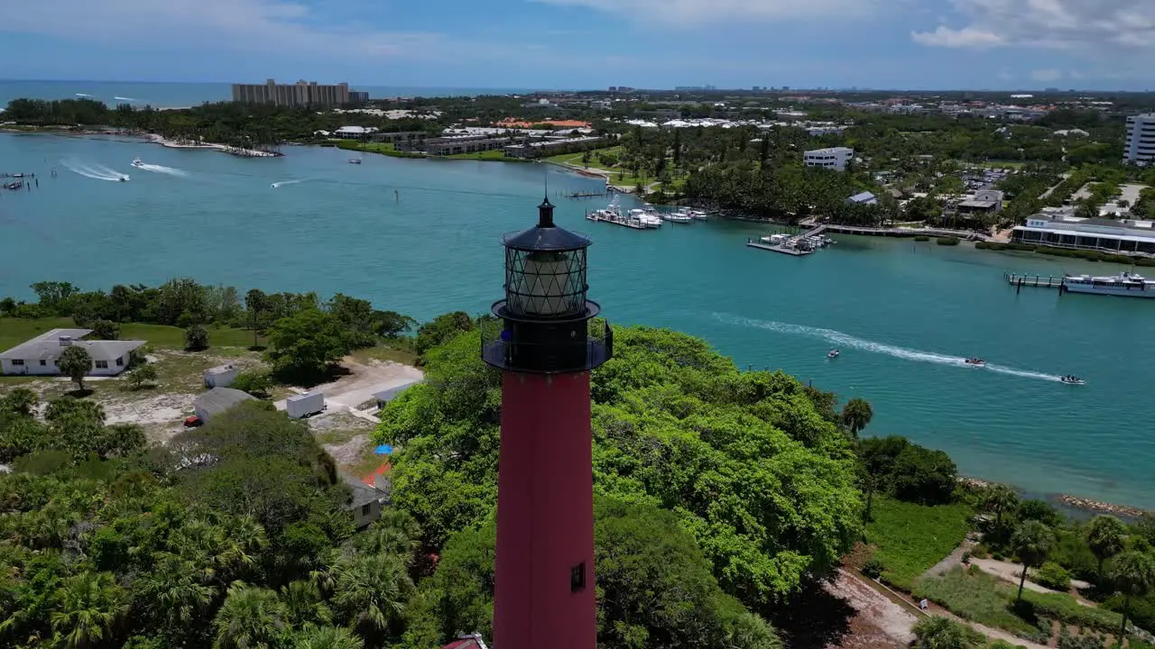 Drone shot of the Jupiter Lighthouse in Florida as boats pass by in the ocean