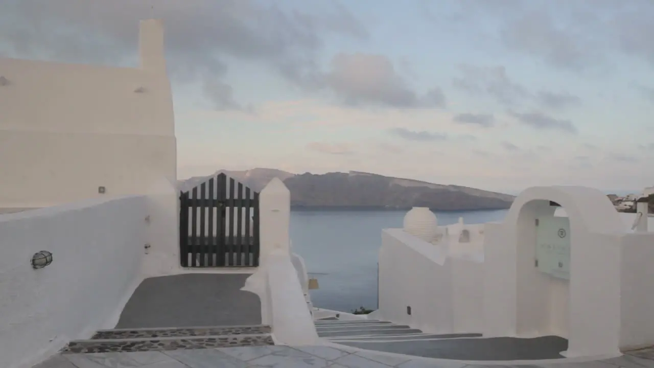 A Greek alley overlooking the majestic view of the caldera in Santorini