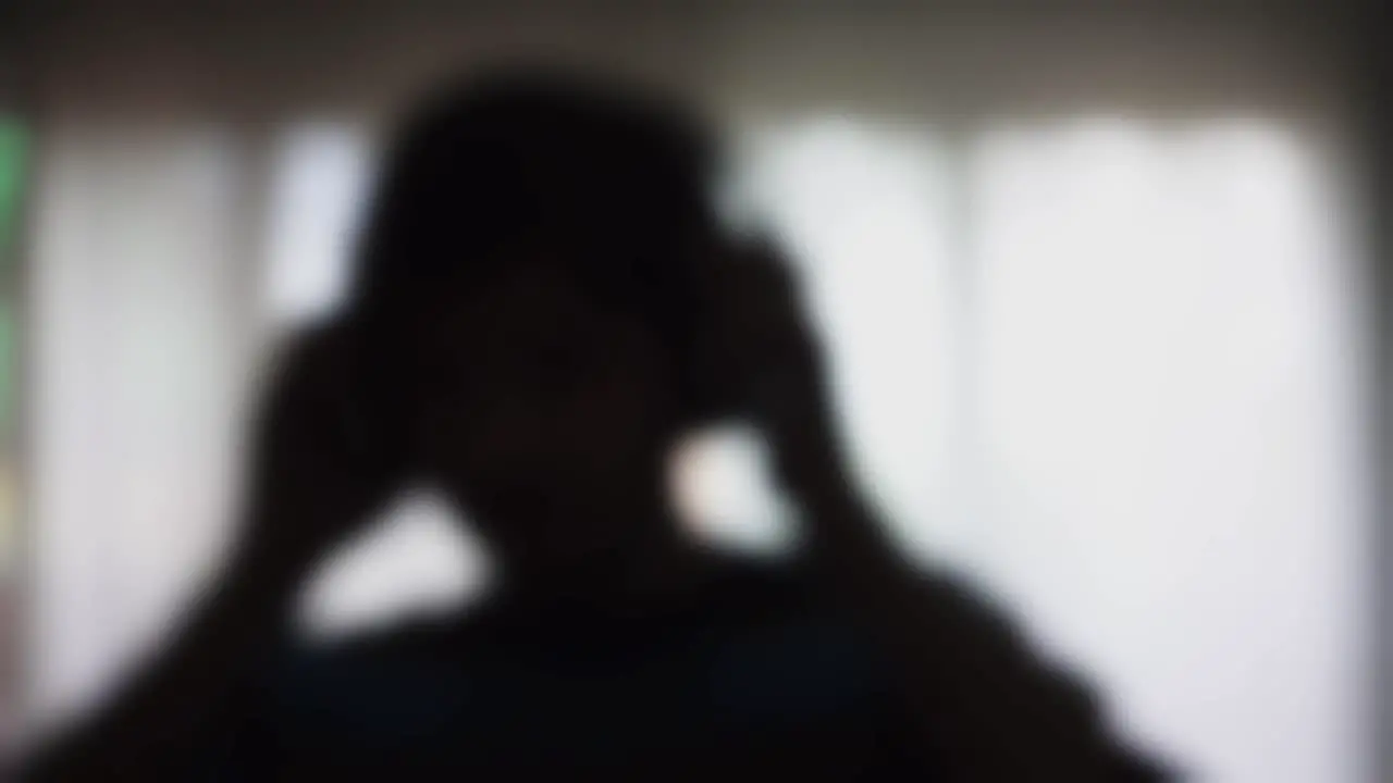 A blur silhouette boy dancing in slow motion while listening music with a headphones