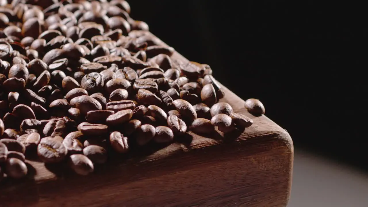 Coffee beans tumble off board slow motion