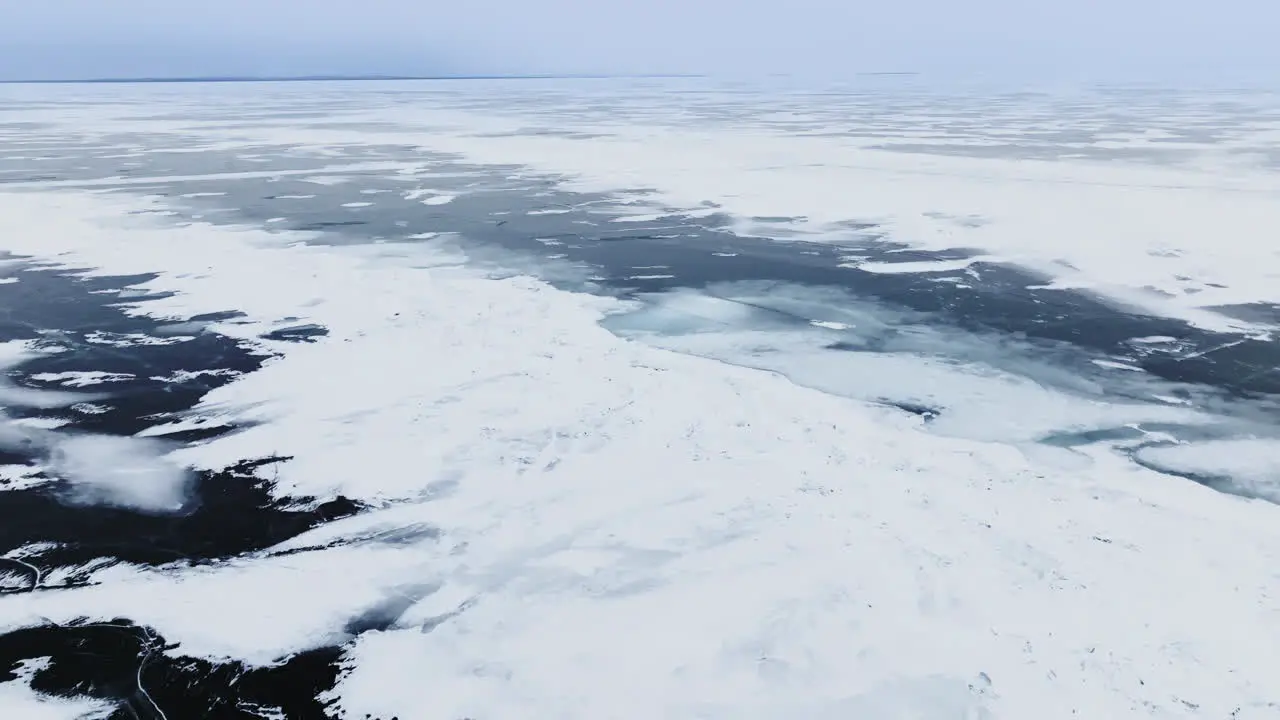 Drone shot of frozen ice and snow drifts on lake Michigan