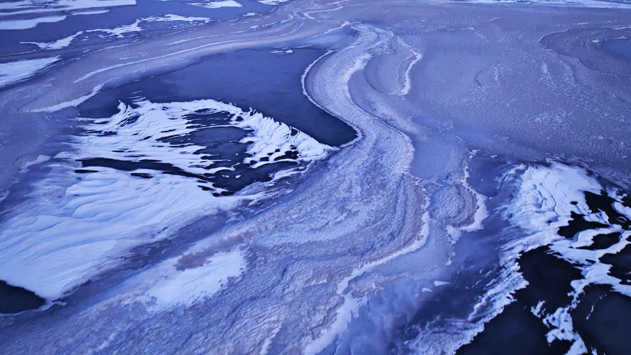 Drone footage capturing the expanse of ice formations in the water