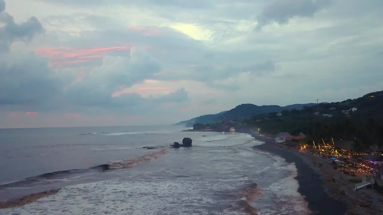 El Tunco beach shoreline during an overcast afternoon in El Salvador Drone dolly in