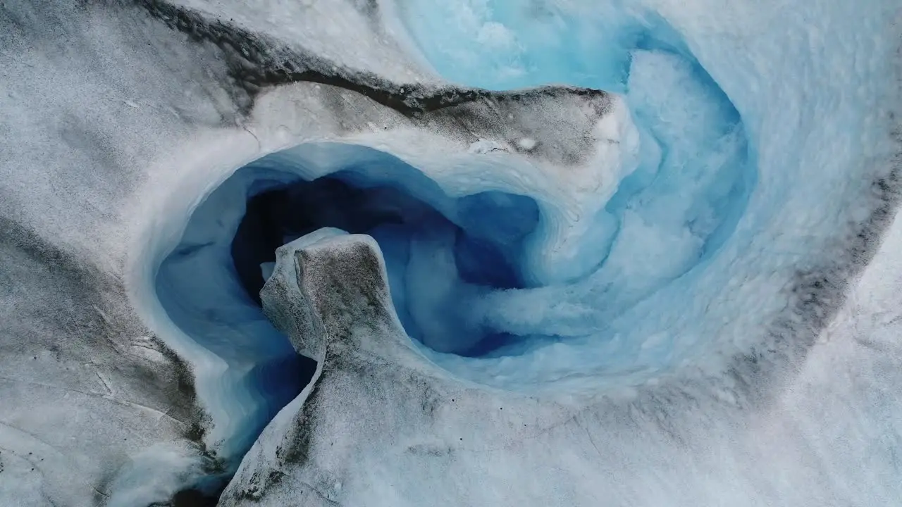 Aerial view of water flowing inside an ice cave