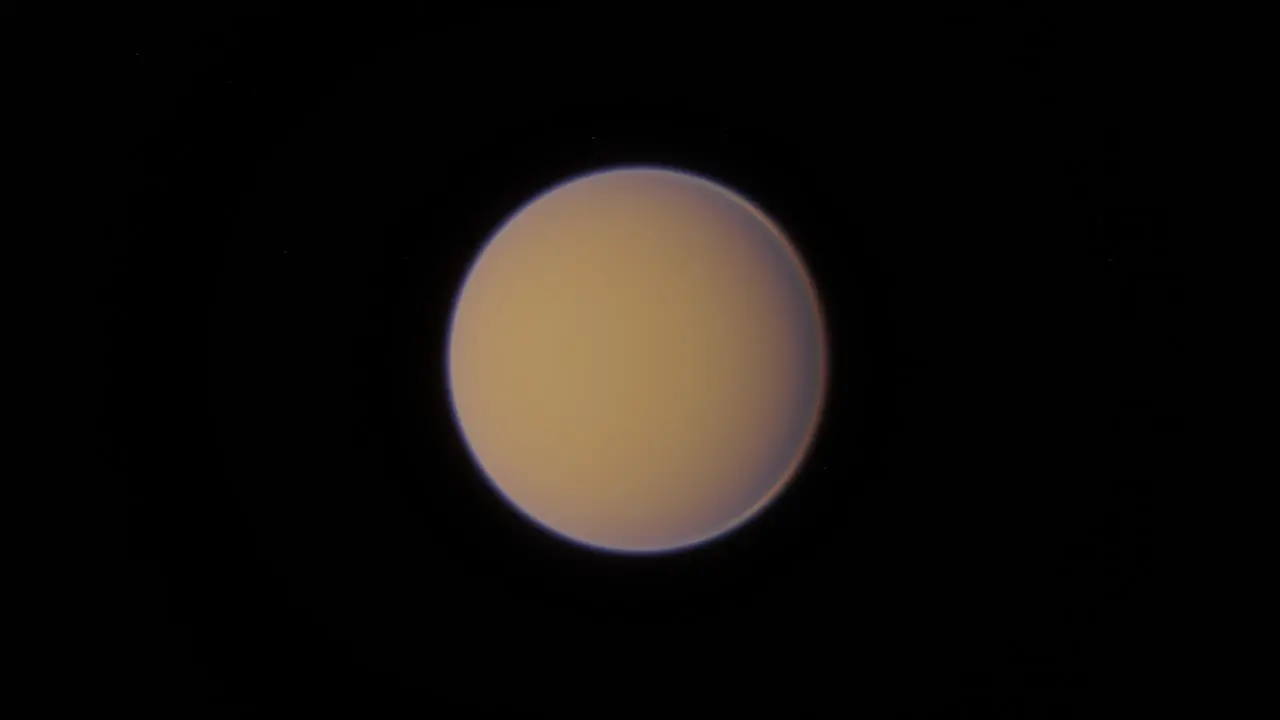 Orbiting Titan the strange alien moon of the planet Saturn