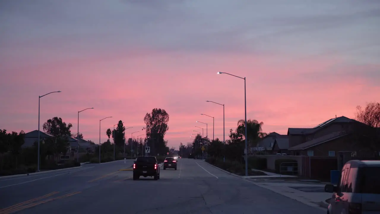 A pastel sky over cars driving away on a road in Clovis CA USA