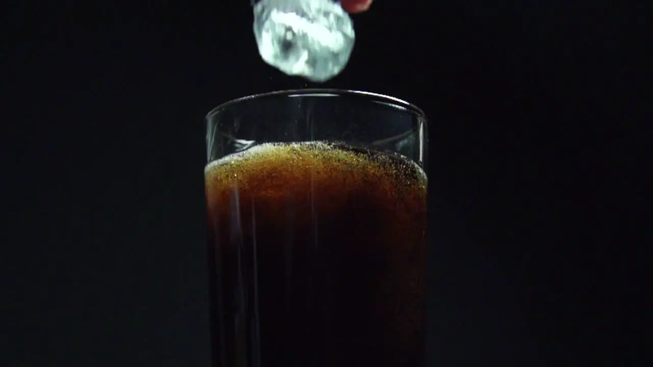 Dropping Ice into Cola