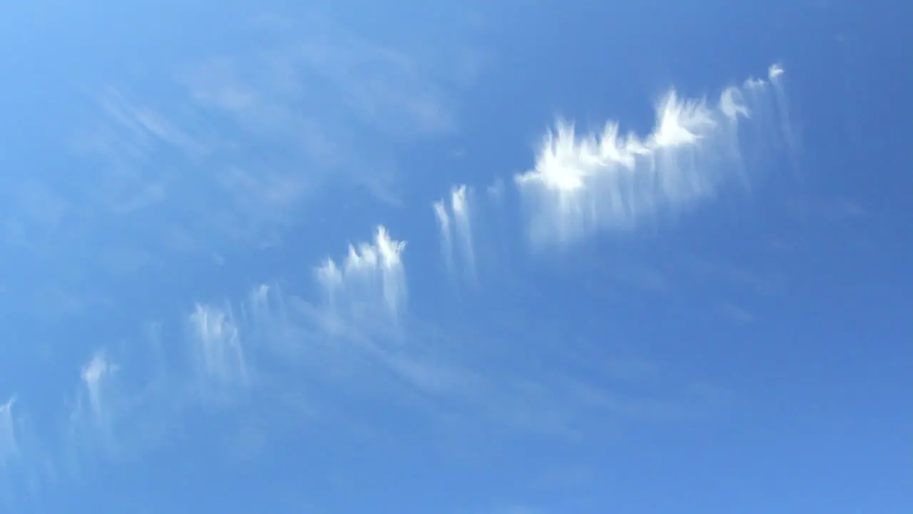 High Altitude Cirrus Clouds With Fall Streaks All In A Row