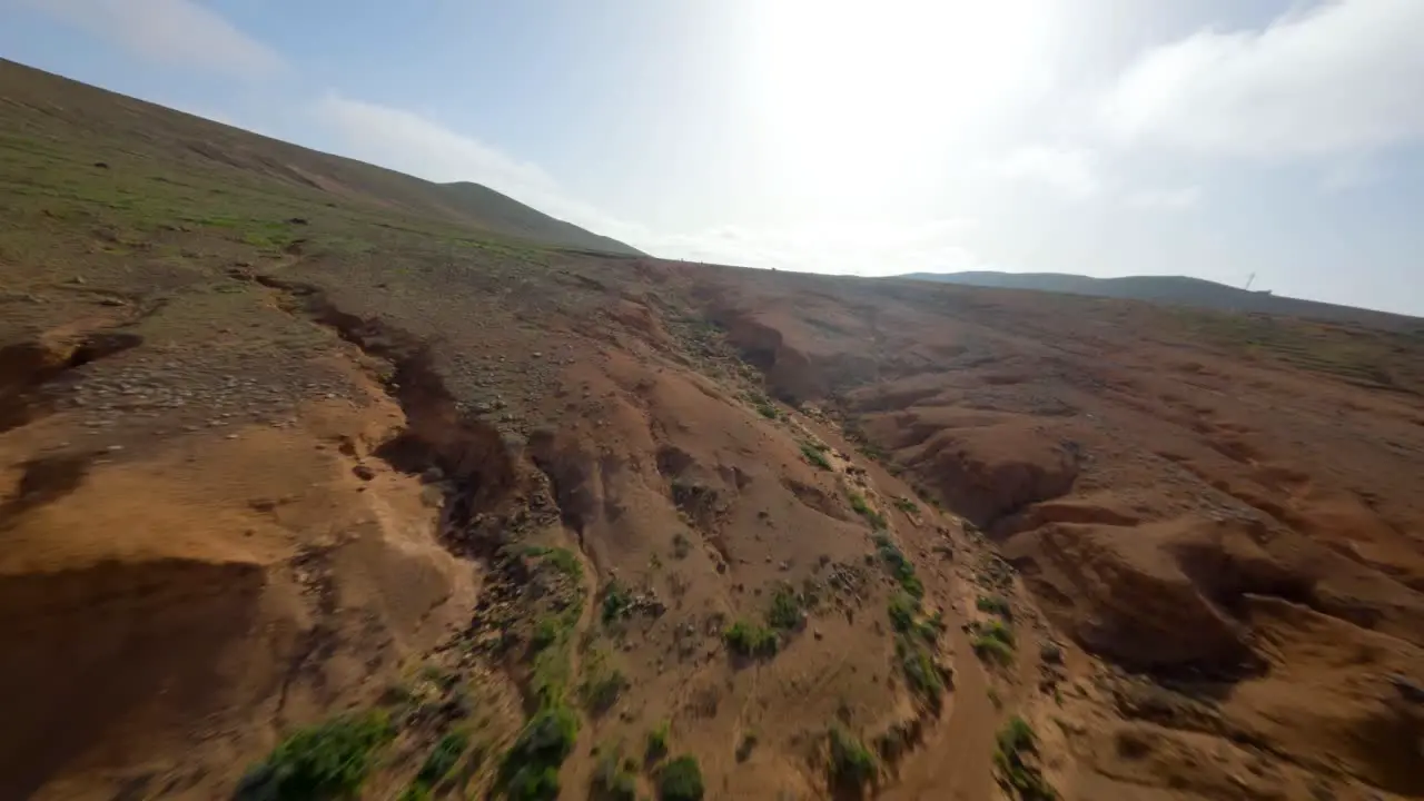 fuerteventura dry landscape fpv dive into dirt crack slowmotion 50fps