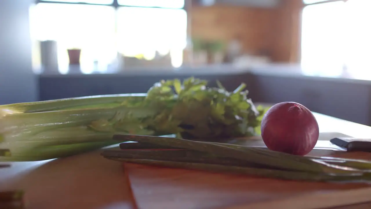 Organic vegetables on countertop in sunny kitchen slow motion