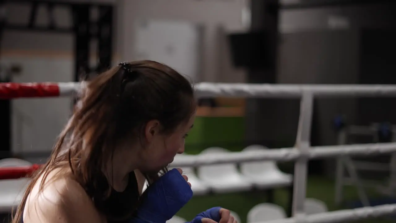 Female Boxer Performing Shadow Fight During Training In Bandages