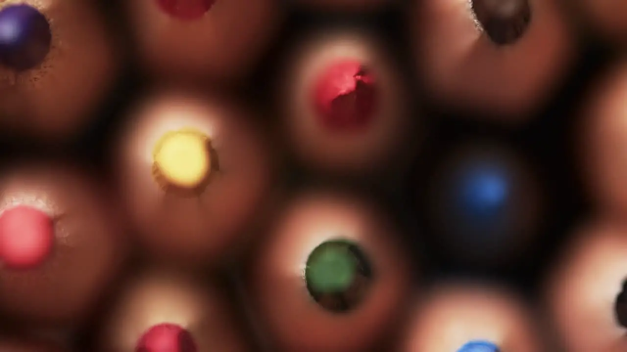 Close up of colourful pencil crayons in slow motion