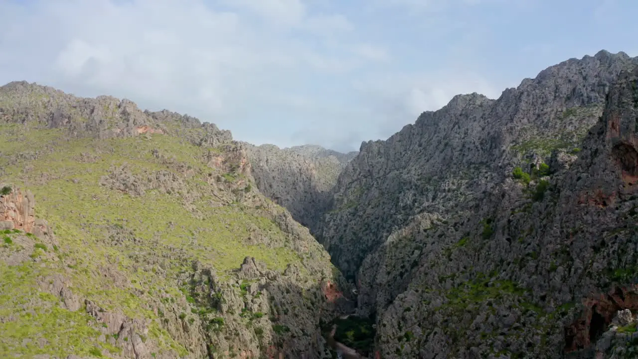 Narrow gorge between two cliffs Vast mountain landscape with atmospheric sky and panoramic views