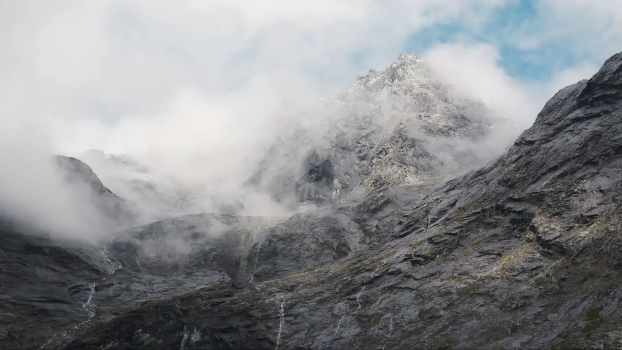 Majestic mountain peak shrouded in ethereal clouds and mist