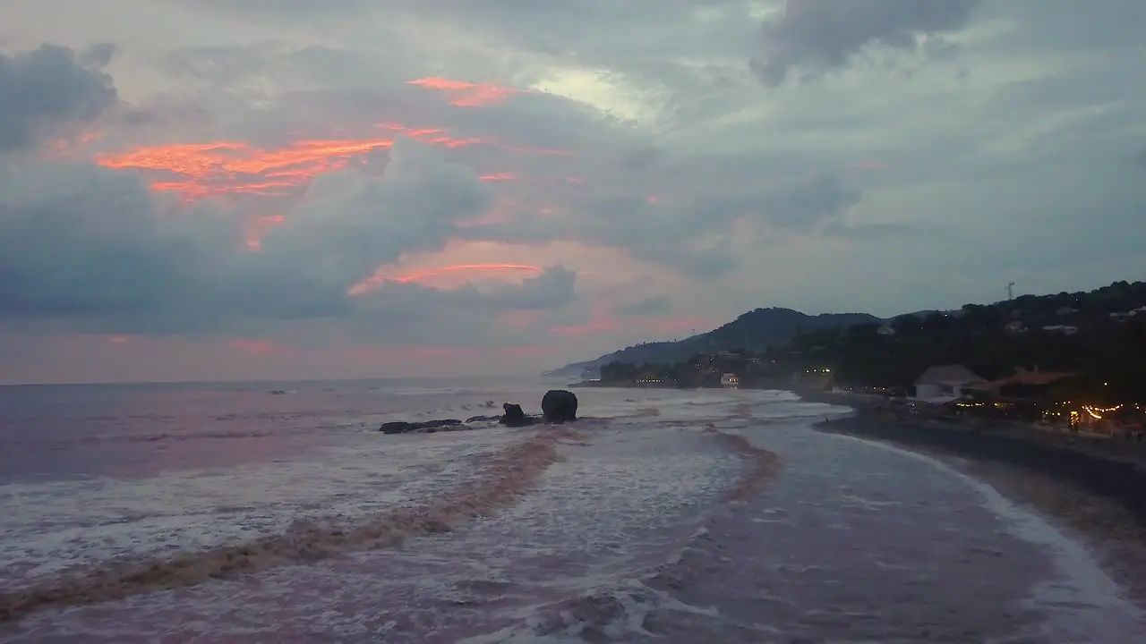 El Tunco beach famous rock formation during an overcast afternoon in El Salvador Drone dolly in