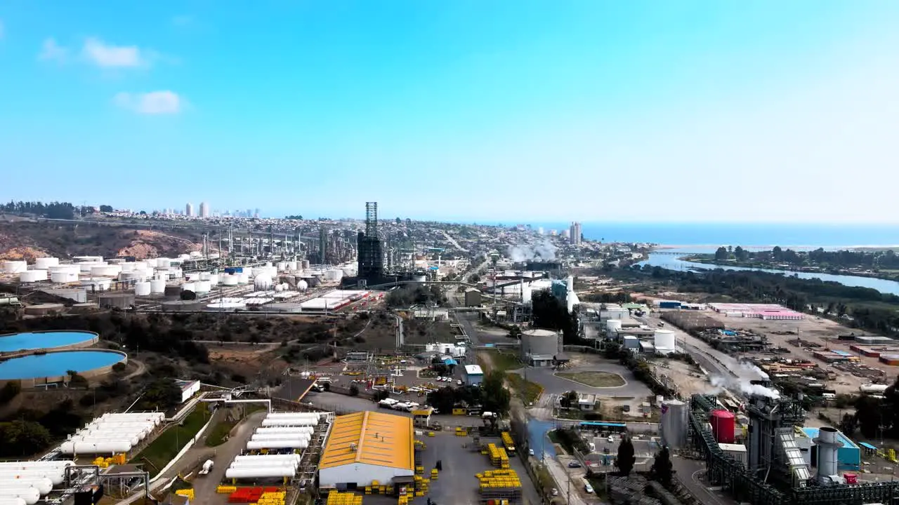 Aerial orbit of an oil refinery on a sunny production day